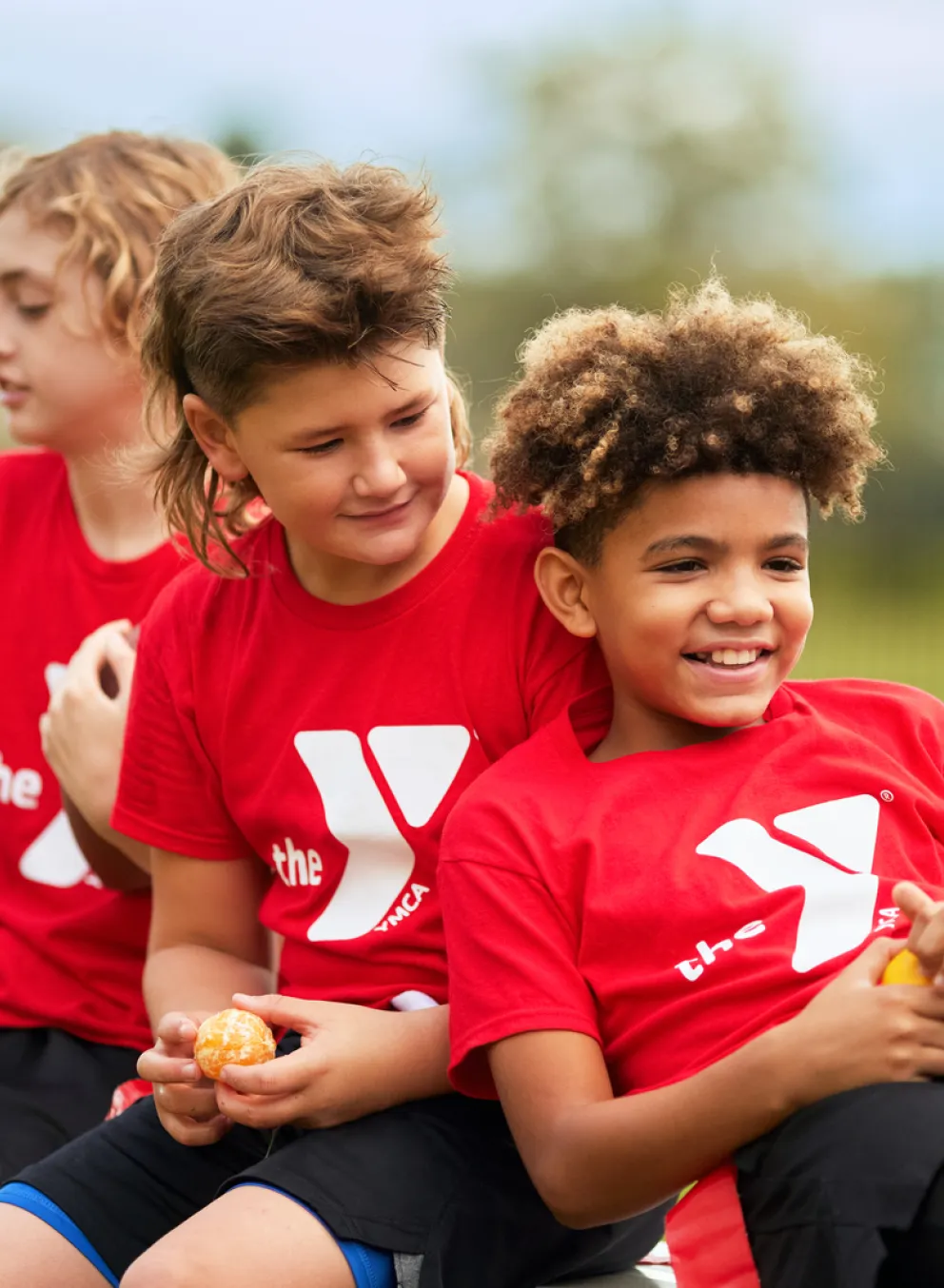 Children in YMCA shirts preparing to participate in Youth Sports.