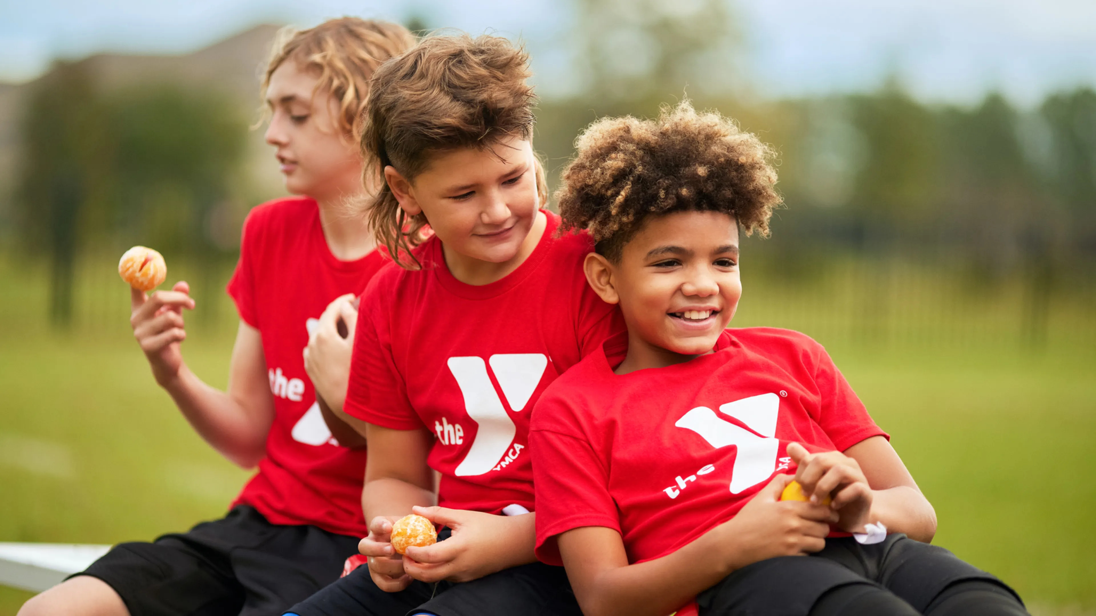 Children in YMCA shirts preparing to participate in Youth Sports.